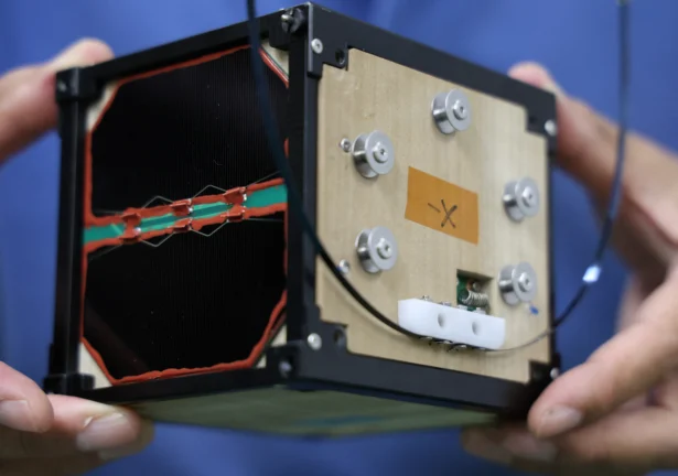 Takao Doi Holds An Engineering Model Of Lignosat During An Interview With Reuters At His Laboratory At Kyoto University In Kyoto