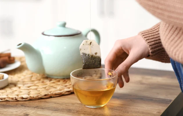 A woman makes tea in a stock photo. (Shutterstock)