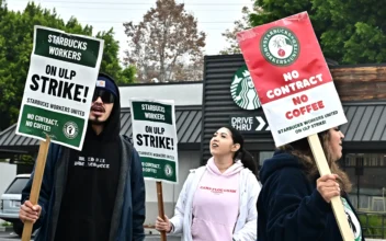 Starbucks workers hold signs as they picket during a strike in front of a Starbucks in Los Angeles on Dec. 24, 2024. (Frederic J. Brown/AFP via Getty Images)