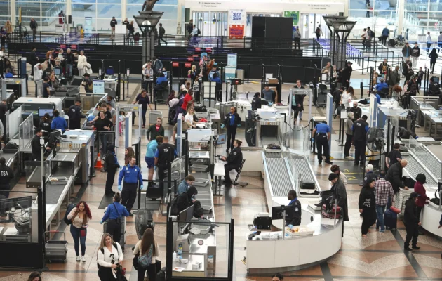 Travelers queue up to pass through the south security checkpoint in the main terminal of Denver International Airport in Denver on Dec. 24, 2024. (David Zalubowski/AP Photo)