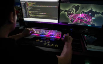 A member of the hacking group Red Hacker Alliance who refused to give his real name, uses a website that monitors global cyberattacks on his computer at their office in Dongguan, Guangdong Province, China, on Aug. 4, 2020. (Nicolas Asfouri/AFP via Getty Images)