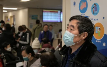 People wearing masks wait at an outpatient area of the respiratory department of a hospital in Beijing, on Jan. 8, 2025. (Jade Gao/AFP via Getty Images)