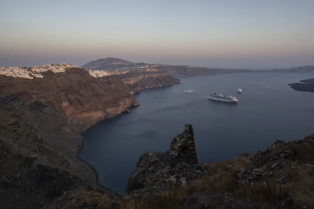 Ruins of a settlement, including a former Catholic monastery, lie on the rocky promontory of Skaros on the Greek island of Santorini on June 15, 2022. (Petros Giannakouris/AP Photo)