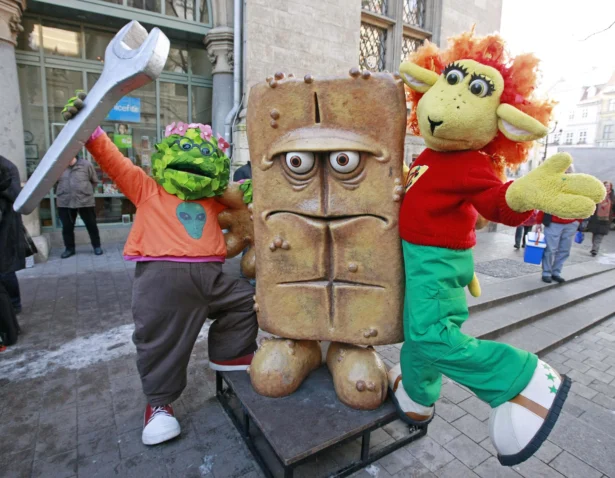 The puppet characters on the German children's television channel 'Kika' 'Briegel der Busch', (L), and 'Chilie das Schaf', (R), present the statue "Bernd das Brot" at his regular place in front of the City hall in Erfurt, Germany, on Feb. 4, 2009. (Jens Meyer/AP Photo)