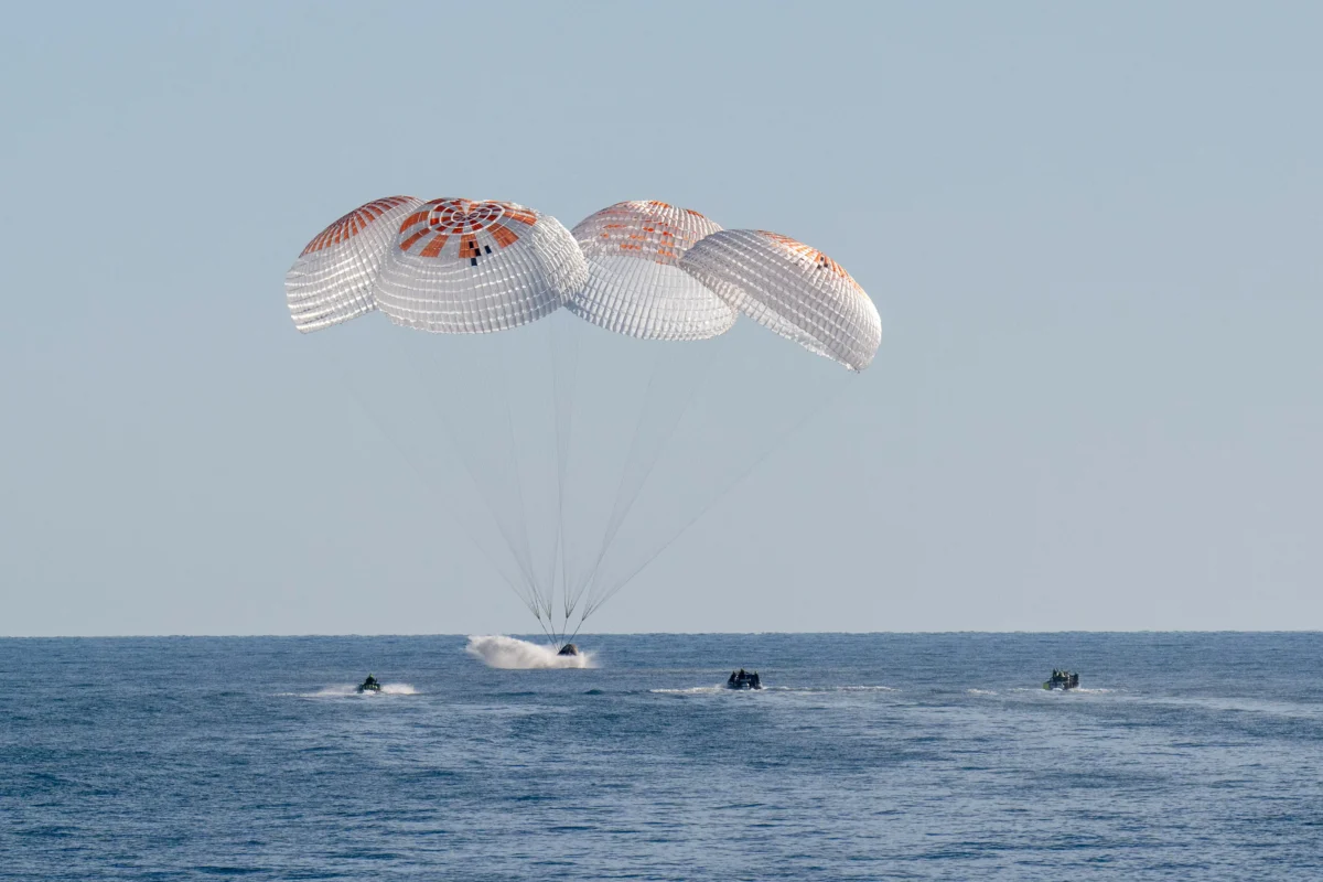 Support teams work around a SpaceX Dragon spacecraft shortly after it landed with NASA astronauts Nick Hague, Suni Williams, Butch Wilmore, and Roscosmos cosmonaut Aleksandr Gorbunov aboard in the water off the coast of Tallahassee, Fla., on March 18, 2025. (Keegan Barber/NASA via Getty Images)