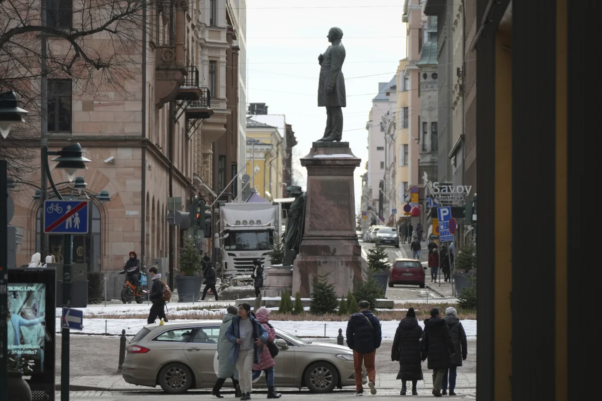 People walk past a monument to poet and writer Johan Ludvig Runeberg in Helsinki, Finland, on March 15, 2025. (Sergei Grits/AP Photo)
