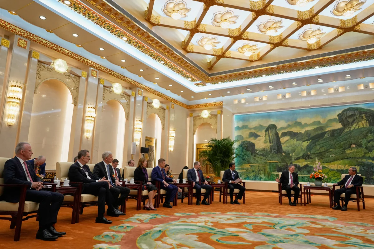 U.S. Sen. Steve Daines (R-Mont.) (2nd R) leads a delegation of U.S. business leaders (L–R) Boeing Global Senior VP Brendan Nelson, Pfizer CEO Albert Bourla, Cargill CEO Brian Sikes, UL Solutions CEO Jennifer Scanlon, Medtronic CEO Geoffrey Martha, Qualcomm CEO Cristiano Amon, and FedEx CEO Raj Subramaniam during a meeting with Chinese Premier Li Qiang (R) in Beijing on March 23, 2025. (Ng Han Guan/Pool/AFP via Getty Images)