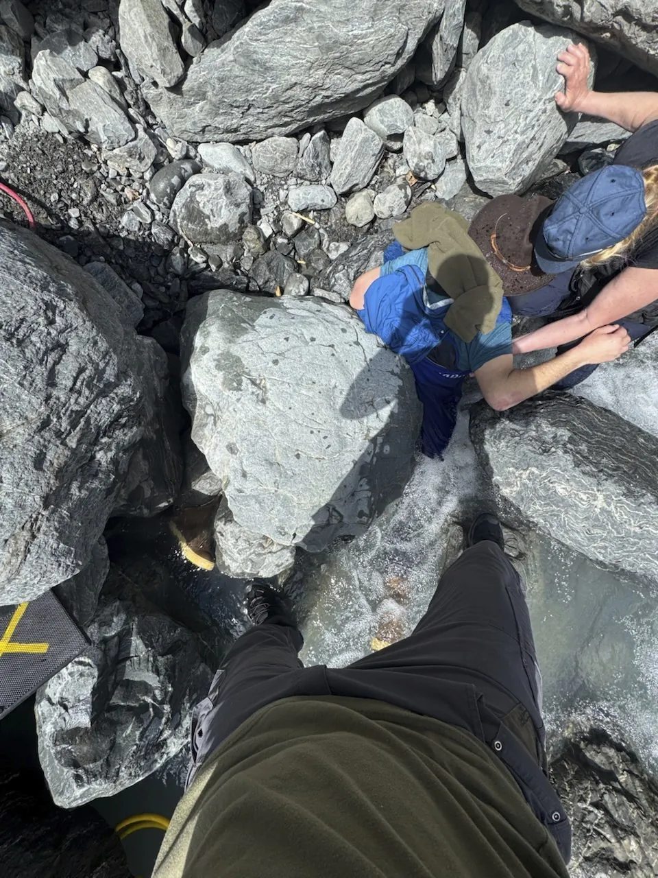 Kell Morris, upper right in a brown hat, trapped under a 700 pound rock near Seward, Alaska, on May 24, 2025. (Jason Harrington/Seward Fire Department via AP)