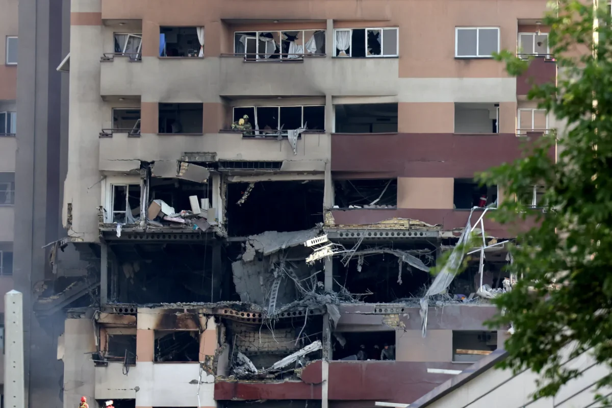 Rescue teams work in a building targeted by an Israeli strike in the Iranian capital Tehran on June 13, 2025. (Atta Kenare/AFP via Getty Images)