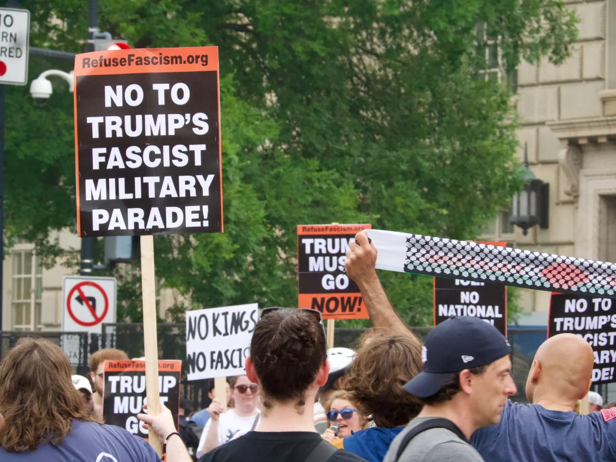 Protesters confronted spectators near Constitution Ave. during the Army's 250th anniversary parade in Washington, D.C., on June 14, 2025. (Travis Gillmore/The Epoch Times)