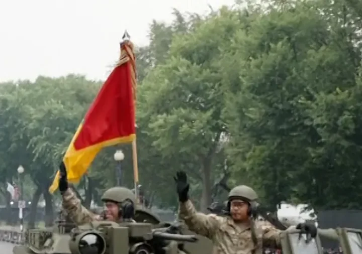 Trump Watches, Applauds, Salutes Military Parade