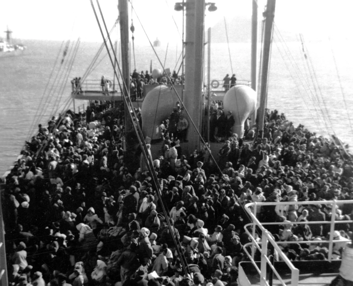 After three days sailing, 14,000 North Korean refugees and five babies, who were born on board the SS Meredith Victory, a U.S. Merchant Marine vessel, arrive at Koje Island, South Korea, on Dec. 26, 1950. (J. Robert Lunney, former Staff officer of SS Meredith Victory via World Peace Freedom United)