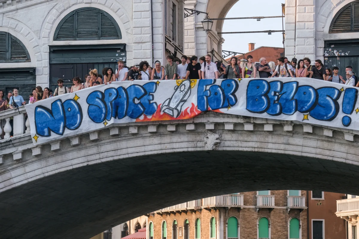 Protesters display a banner reading "No Space for Bezos!" on the Rialto Bridge during a protest against Amazon founder Jeff Bezos' upcoming wedding to Lauren Sanchez, being held in Venice, Italy, on June 13, 2025. (Manuel Silvestri/Reuters)