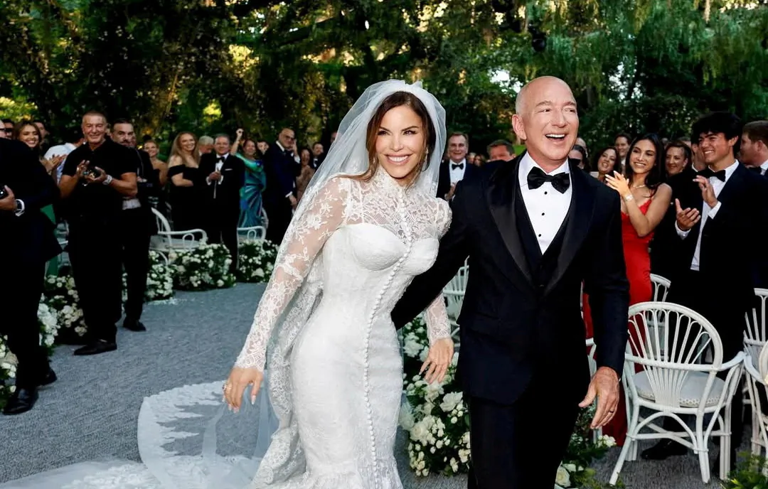 Amazon founder Jeff Bezos (R) and media personality Lauren Sanchez Bezos react on the day of their wedding in Venice, Italy, on June 27, 2025. (@laurensanchezbezos via Instagram via Reuters)