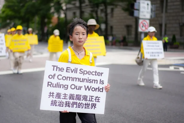 Falun Dafa practitioners take part in a march calling for the end of the Chinese Communist Party’s 26 years of persecution of Falun Gong in China, in Washington on July 17, 2025. (Madalina Kilroy/The Epoch Times)