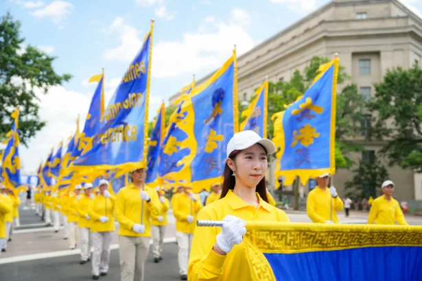 Falun Dafa practitioners take part in a march calling for the end of the Chinese Communist Party’s 26 years of persecution of Falun Gong in China, in Washington on July 17, 2025. (Samira Bouaou/The Epoch Times)