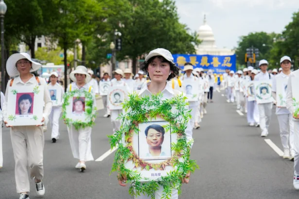 Falun Dafa practitioners take part in a march calling for the end of the Chinese Communist Party’s 26 years of persecution of Falun Gong in China, in Washington on July 17, 2025. (Samira Bouaou/The Epoch Times)