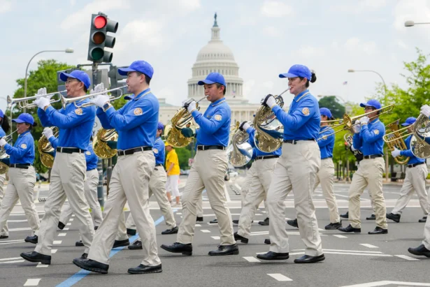 Falun Dafa practitioners take part in a march calling for the end of the Chinese Communist Party’s 26 years of persecution of Falun Gong in China, in Washington on July 17, 2025. (Madalina Kilroy/The Epoch Times)