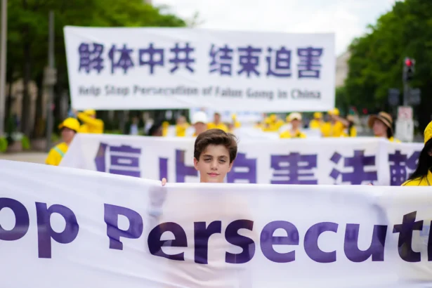 Falun Dafa practitioners take part in a march calling for the end of the Chinese Communist Party’s 26 years of persecution of Falun Gong in China, in Washington on July 17, 2025. (Madalina Kilroy/The Epoch Times)