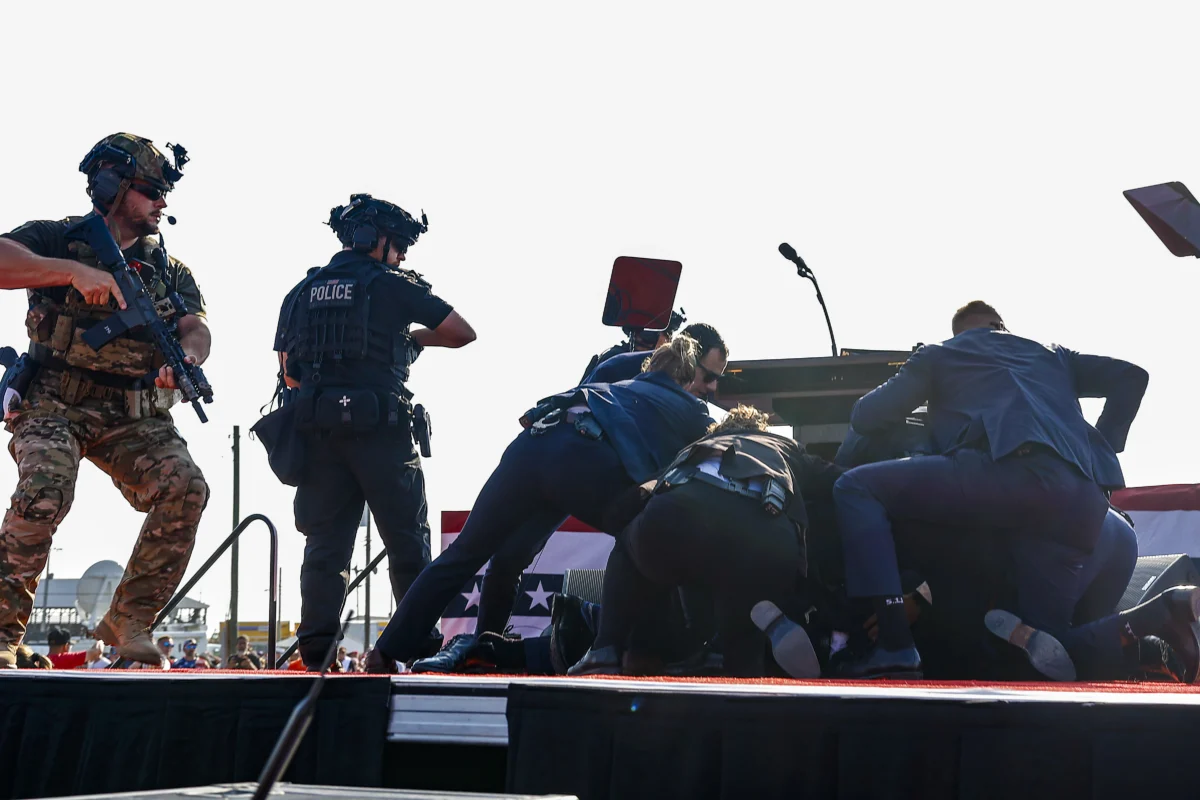 Republican presidential candidate former President Donald Trump is covered by U.S. Secret Service agents after a shooter attempted to assassinate him during a rally in Butler, Pa., on July 13, 2024. (Anna Moneymaker/Getty Images)