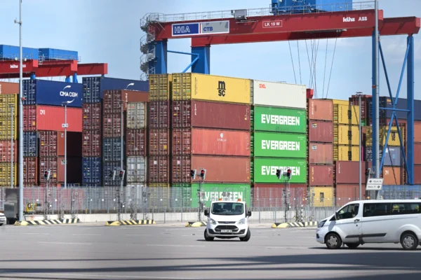 Cargo shipping containers are loaded with cranes on container ships at the Burchardkai container terminal at the harbour of Hamburg, northern Germany, on June 3, 2025. (Photo by FABIAN BIMMER / AFP)