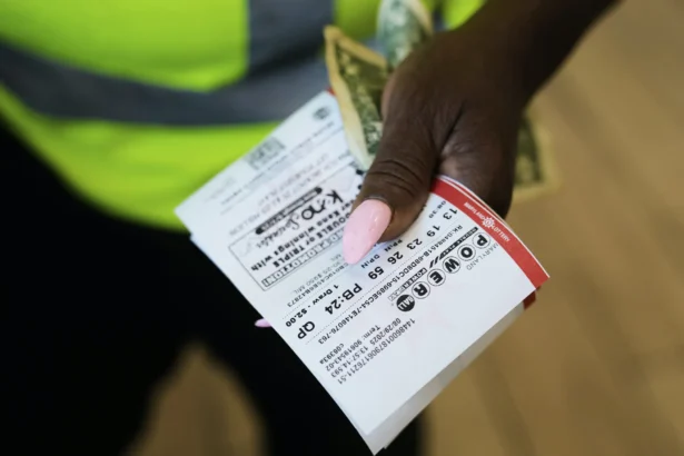 Roslyn Jefferson holds her Powerball lottery tickets ahead of Saturday's Powerball drawing offering of $1 billion on Aug. 29, 2025. (Stephanie Scarbrough/AP Photo)