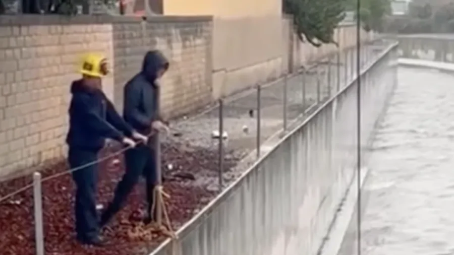 Firefighters Rescue Man Trapped on Ledge Above Rushing Stormwater