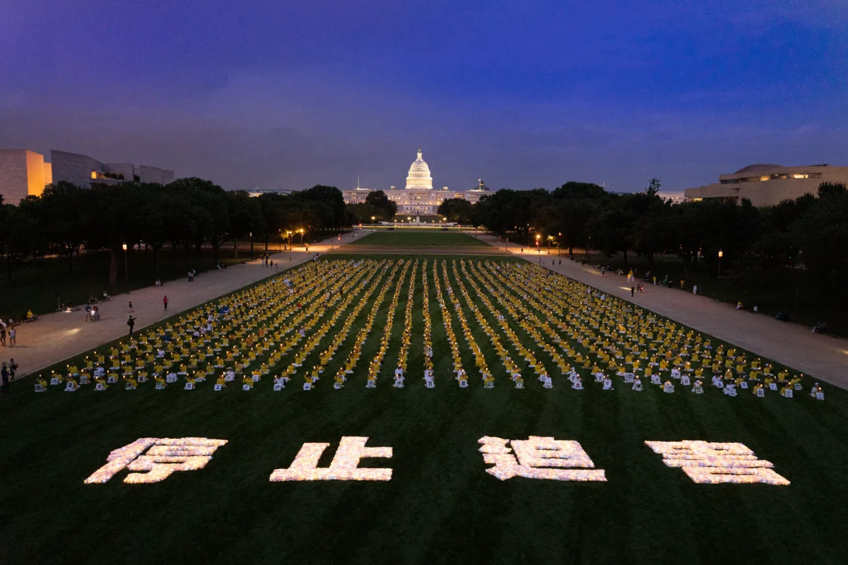 Falun Gong practitioners take part in a candlelight vigil commemorating fellow practitioners who were persecuted to death by the Chinese Communist Party in China, in Washington on July 17, 2025. (Larry Dye/The Epoch Times)