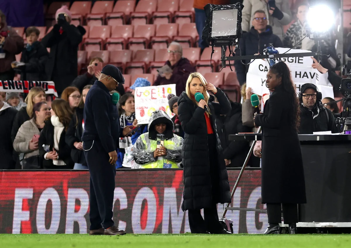 Presenters Ian Wright, Katie Shanahan, Anita Asante look on after presenter Laura Woods (not pictured) collapsed earlier in the evening, after the Women's international friendly match between England and Ghana at St Mary's Stadium in Southampton, England, on Dec. 2, 2025. (Warren Little/Getty Images)