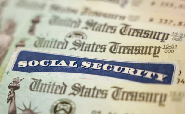 In this photo illustration, a Social Security card sits alongside checks from the U.S. Treasury in Washington, DC, on Oct. 14, 2021. (Kevin Dietsch/Getty Images)