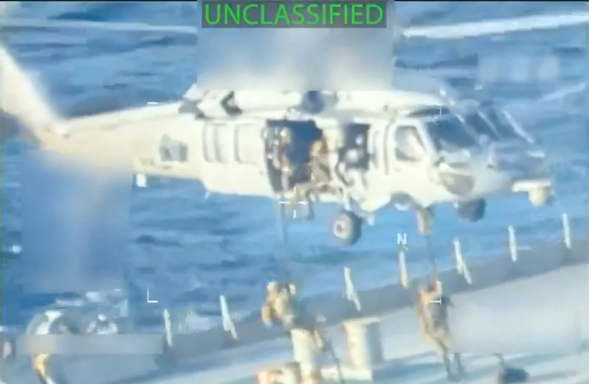 U.S. forces abseil onto an oil tanker during a raid described by U.S. Attorney General Pam Bondi as its seizure by the United States off the coast of Venezuela, December 10, 2025, in a still image from video. (U.S. Attorney General/Handout via Reuters).