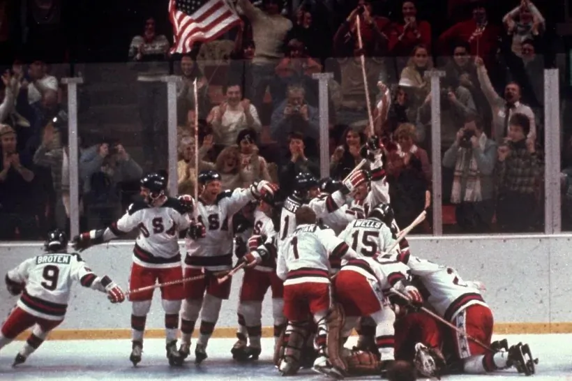 The U.S. hockey team pounces on goalie Jim Craig after a 4–3 victory against the Soviets in the 1980 Olympics in Lake Placid, N.Y., on Feb. 22, 1980. (AP Photo)
