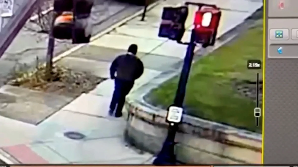 A monitor shows security camera footage of what police say is the Brown University shooting suspect walking along Hope Street in Providence, R.I., after leaving the scene of shooting on Dec. 13, 2025. (Providence Public Information Officer/Handout via Reuters)