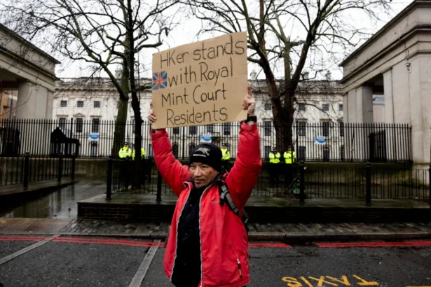 A protester holds a placard during a demonstration against the proposed site for the new Chinese Embassy, outside Royal Mint Court in London on Feb. 8, 2025. (Carlos Jasso/Reuters)