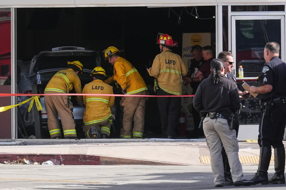 First responders gather around a car seen inside of a 99 Ranch Market at the scene of a fatal crash in the Westwood neighborhood of Los Angeles on Feb. 5, 2026. (Damian Dovarganes/AP Photo)