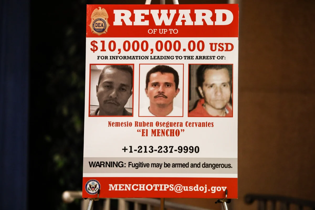 A poster shows the $10 million reward notice for the kingpin of the Cartel de Jalisco Nuevo Generacion, Nemesio Oseguera Cervantes, also known as “El Mencho,” at the Justice Department in Washington on March 11, 2020. (Charlotte Cuthbertson/The Epoch Times)