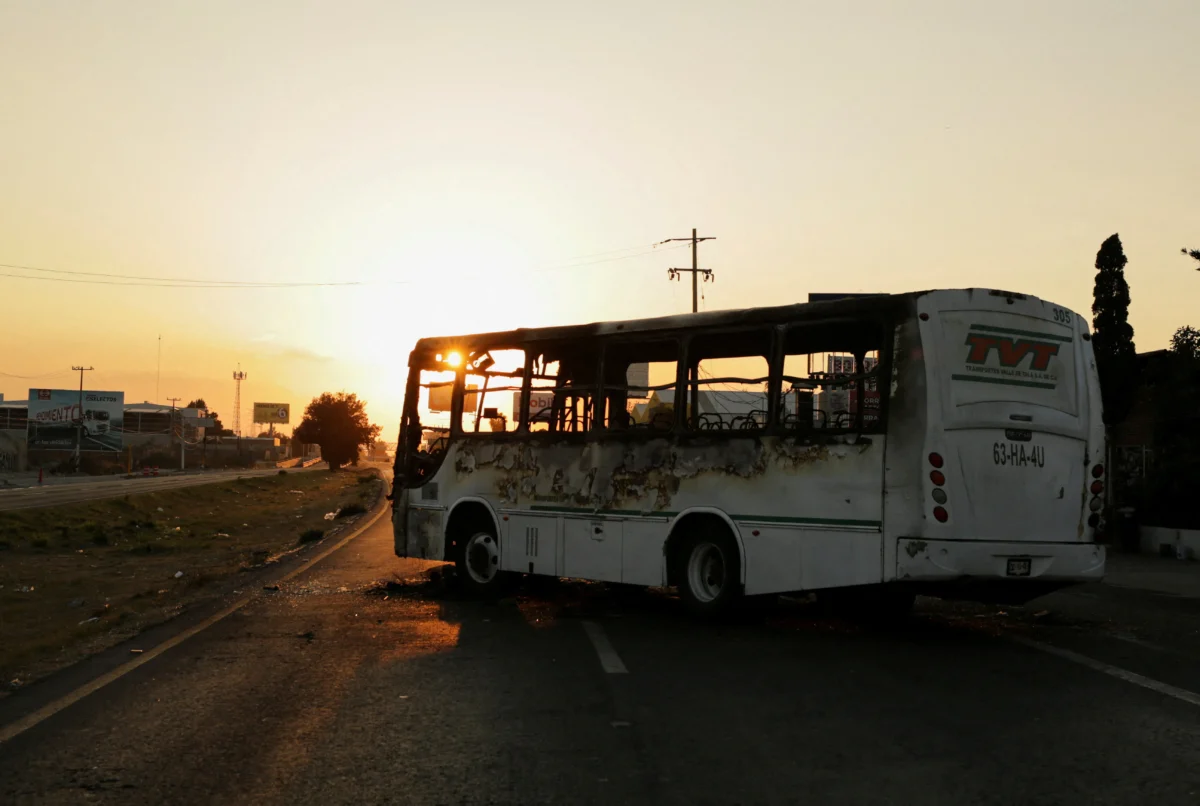 A burnt bus set up as a blockade by members of organized crime following a military operation in which Mexican officials said cartel boss Nemesio Oseguera, "El Mencho," was killed on Feb. 22, 2026. (Gabriel Trujillo/Reuters)