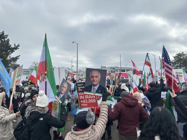 Demonstrators demanding regime change in Iran, holding pre-1979 revolution Iranian national flags and pictures of the exiled Crown Prince Reza Pahlavi, protest in Toronto on Feb. 14, 2026. (The Epoch Times)