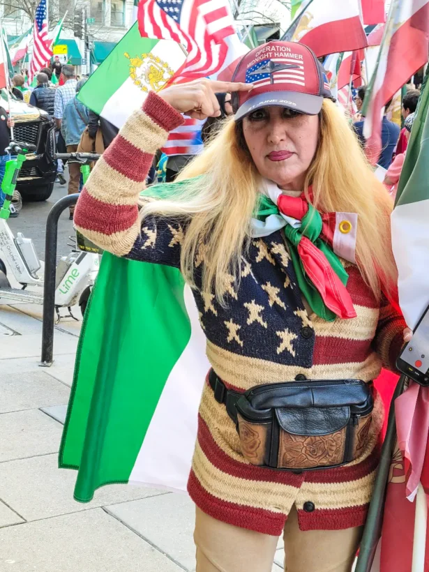 A woman who identified herself as “Anita,” shows off her pro-U.S. and pro-Iranian attire as she and others celebrate the U.S.-Israeli strikes against Iran during a march in Washington, D.C., on Feb. 28, 2026. (Stacy Robinson/The Epoch Times)