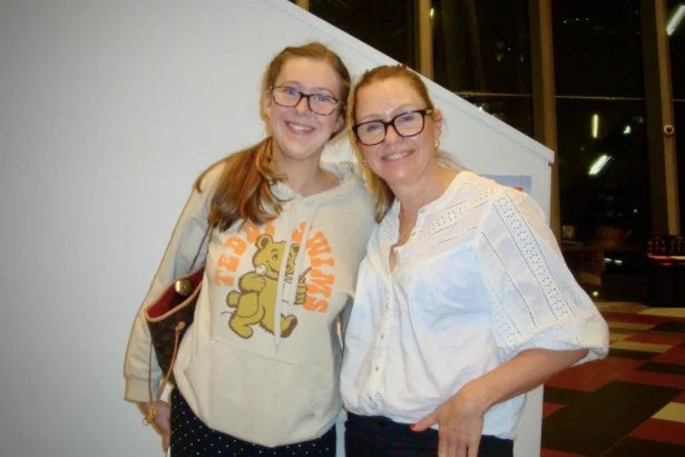 Kristy Belleville (R) attends Shen Yun Performing Arts with her daughter at the Melbourne Convention and Exhibition Centre in Melbourne on March 13, 2026. (Mike Deng/The Epoch Times)