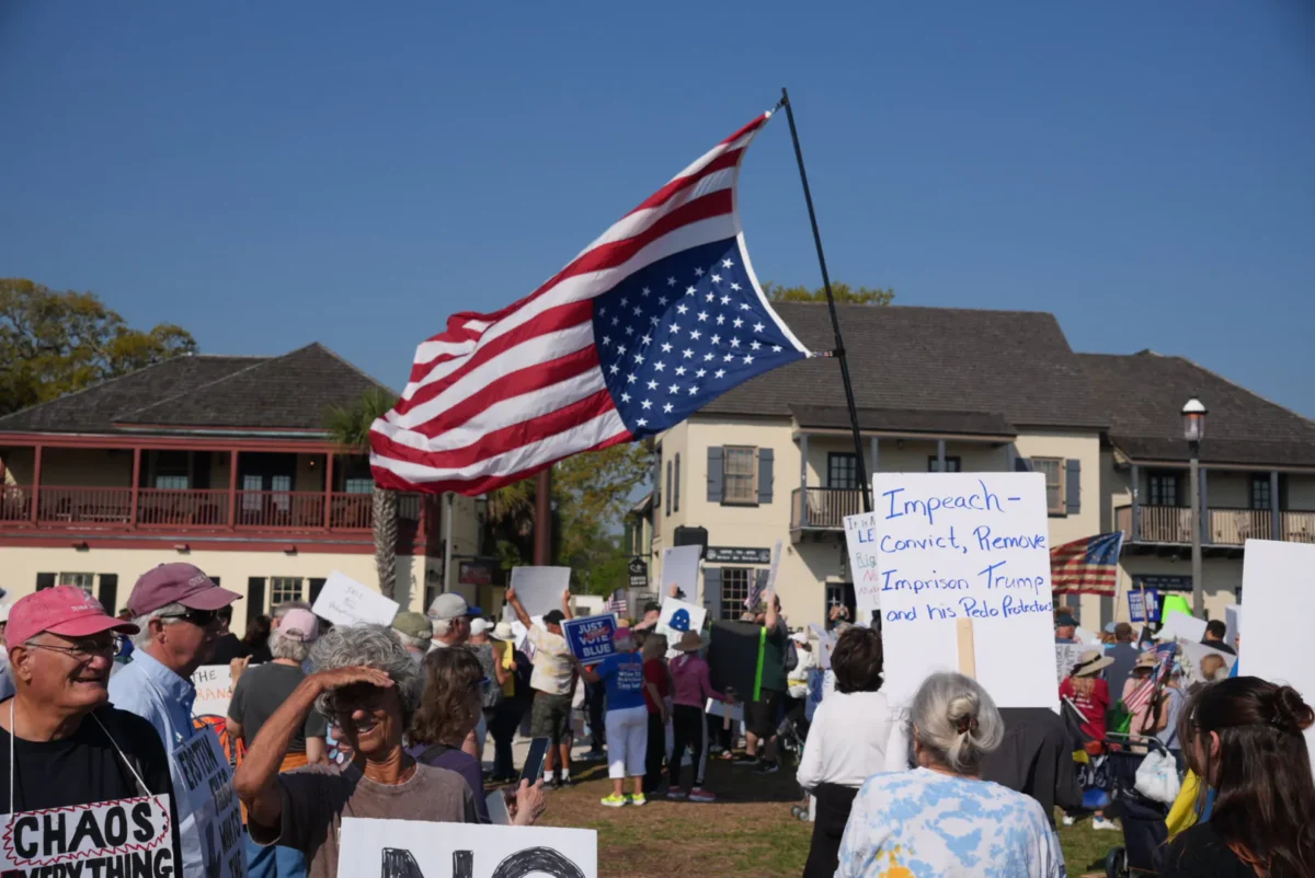 A man who wished to go by Tony D. carried around an American flag during a "No Kings" protest in St. Augustine, Fla., on March 28, 2026. (Troy Myers/The Epoch Times)