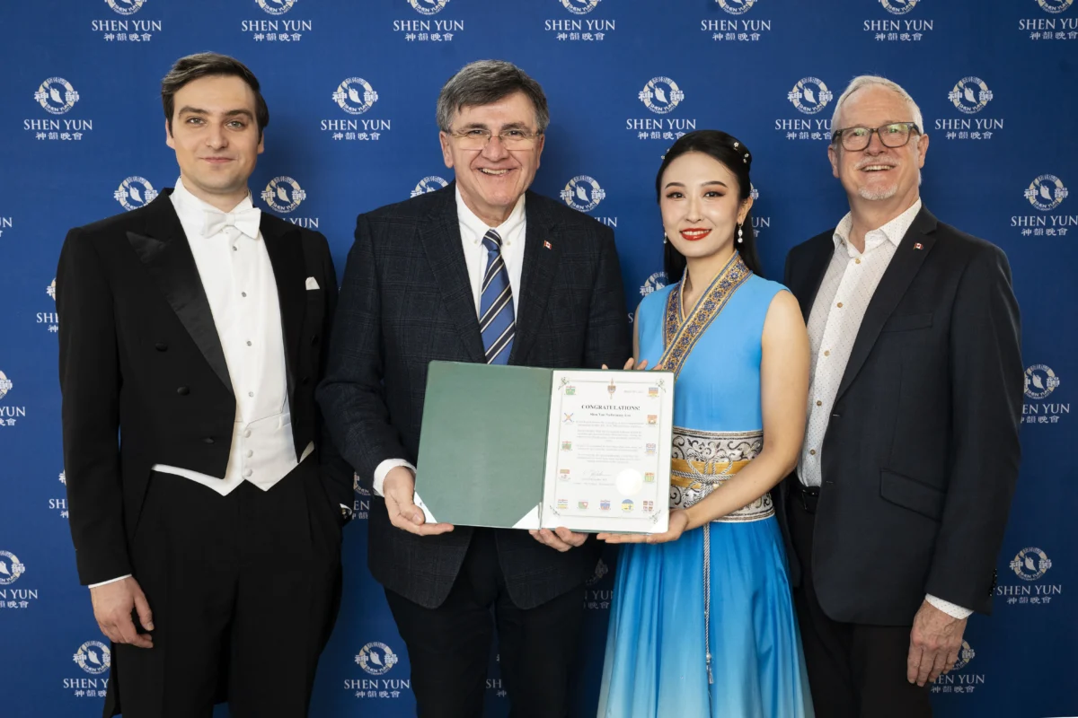 Conservative MP Costas Menegakis (2nd L) and former Conservative MP Colin Carrie (R) present Shen Yun hosts with a proclamation at the Four Seasons Centre for the Performing Arts in Toronto on March 28, 2026. (The Epoch Times)