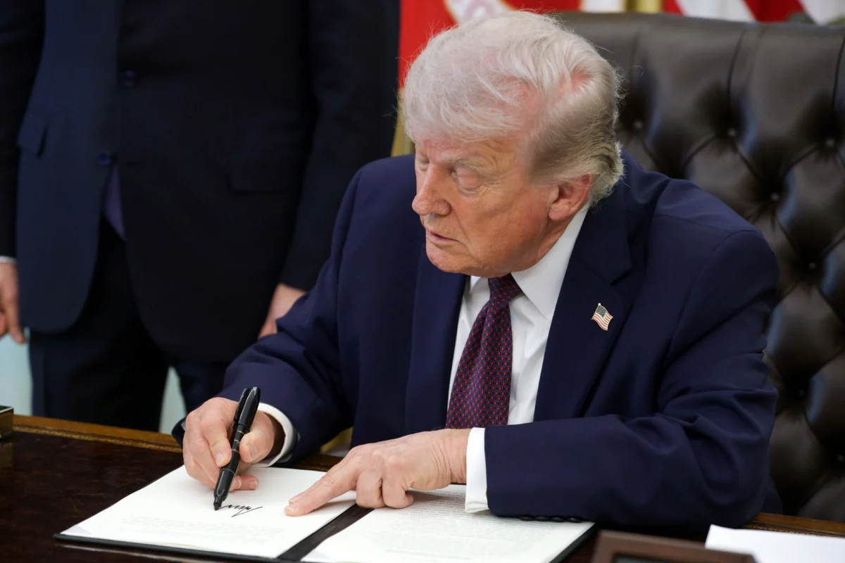 President Donald Trump signs an executive order to limit mail-in voting in the Oval Office of the White House on March 31, 2026. (Alex Wong/Getty Images)