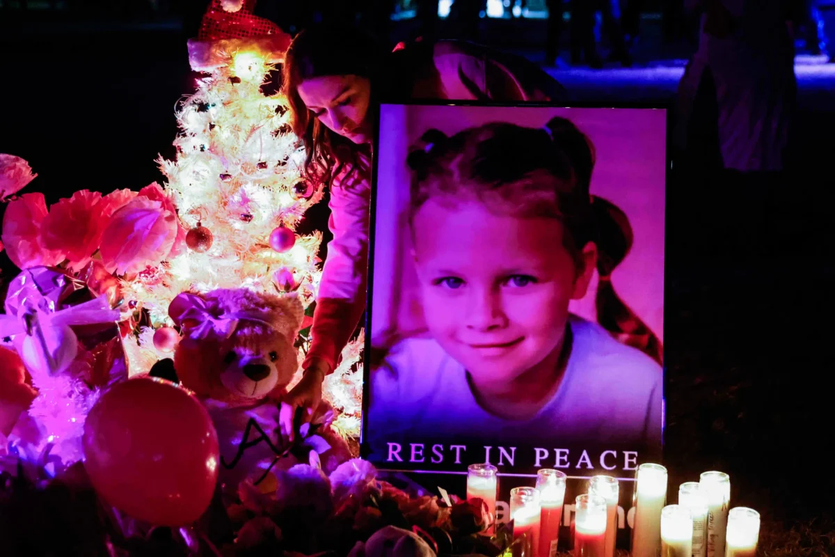 Attendees offer their respects at a makeshift memorial for Athena Strand after a memorial service in Paradise, Texas, on Dec. 6, 2022. (Shafkat Anowar/The Dallas Morning News via AP)