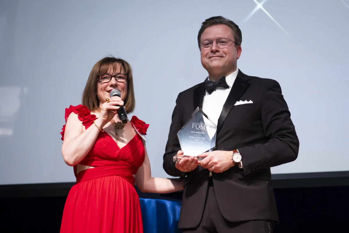Isabelle Karamooz, founder, CEO, and publisher of French Quarter Magazine, presents the magazine's 2026 Best Author of the Year award to Jan Jekielek, Epoch Times senior editor and author of "Killed to Order," at the French Embassy in Washington on April 20, 2026. (Madalina Kilroy / The Epoch Times)