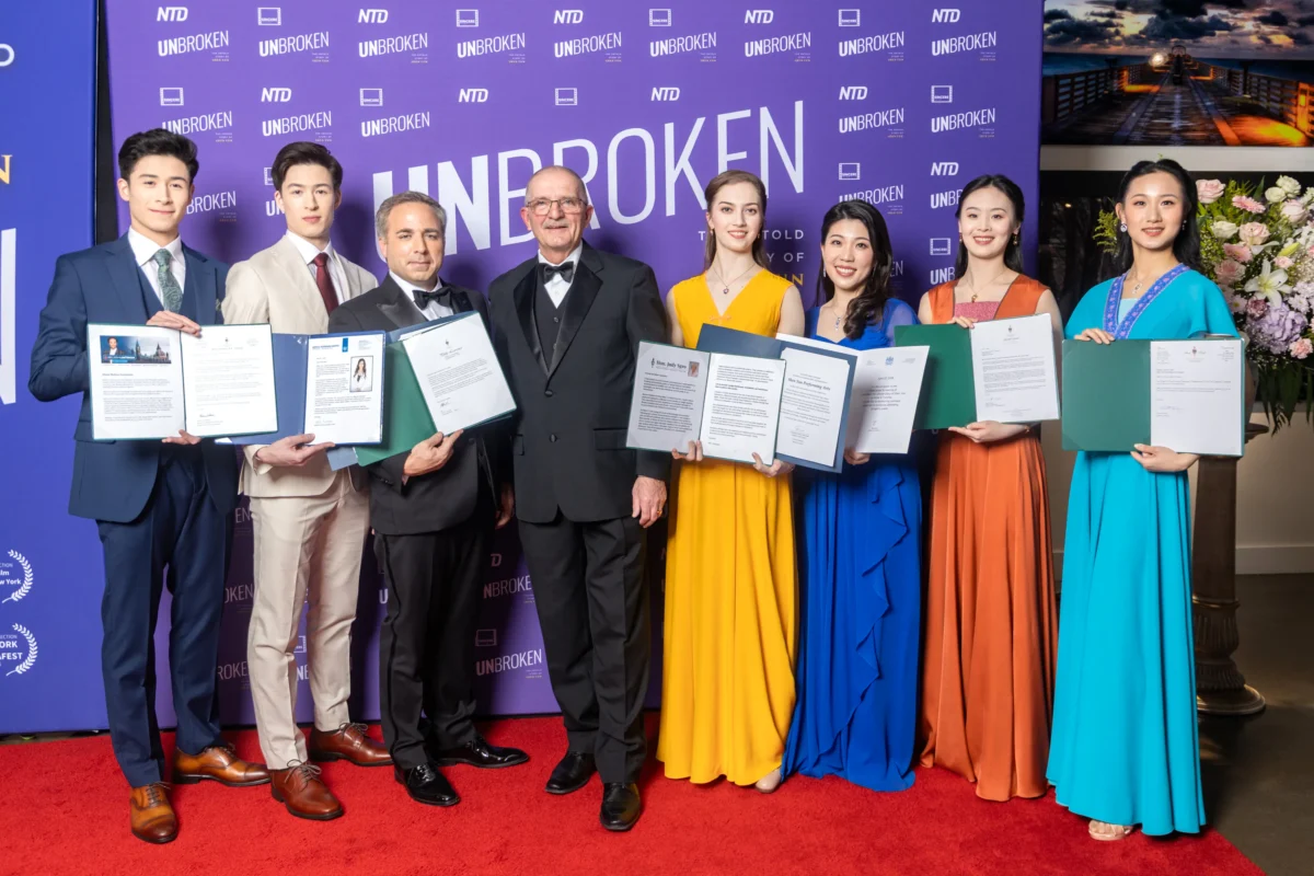 (L–R) Shen Yun dancers Lucas Browde and Jesse Browde, the film’s producer Steve Lance, former Conservative MP Wladyslaw Lizon, Shen Yun dancer Lillian Parker, Shen Yun violist Rachel Chen, and Shen Yun dancers Sunni Zhou and Zheng Yingmei at the Canadian premiere of the documentary "Unbroken: The Untold Story of Shen Yun" at Hotel X Toronto on April 22, 2026. (Courtesy of Alex Gurevich)