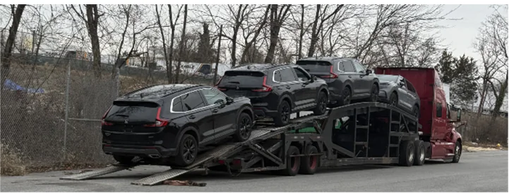 A car transporter in Maryland was loaded with several of the recovered vehicles from an alleged international auto-theft ring that federal authorities say was connected to six people in the Washington metropolitan area. (U.S. DOJ)