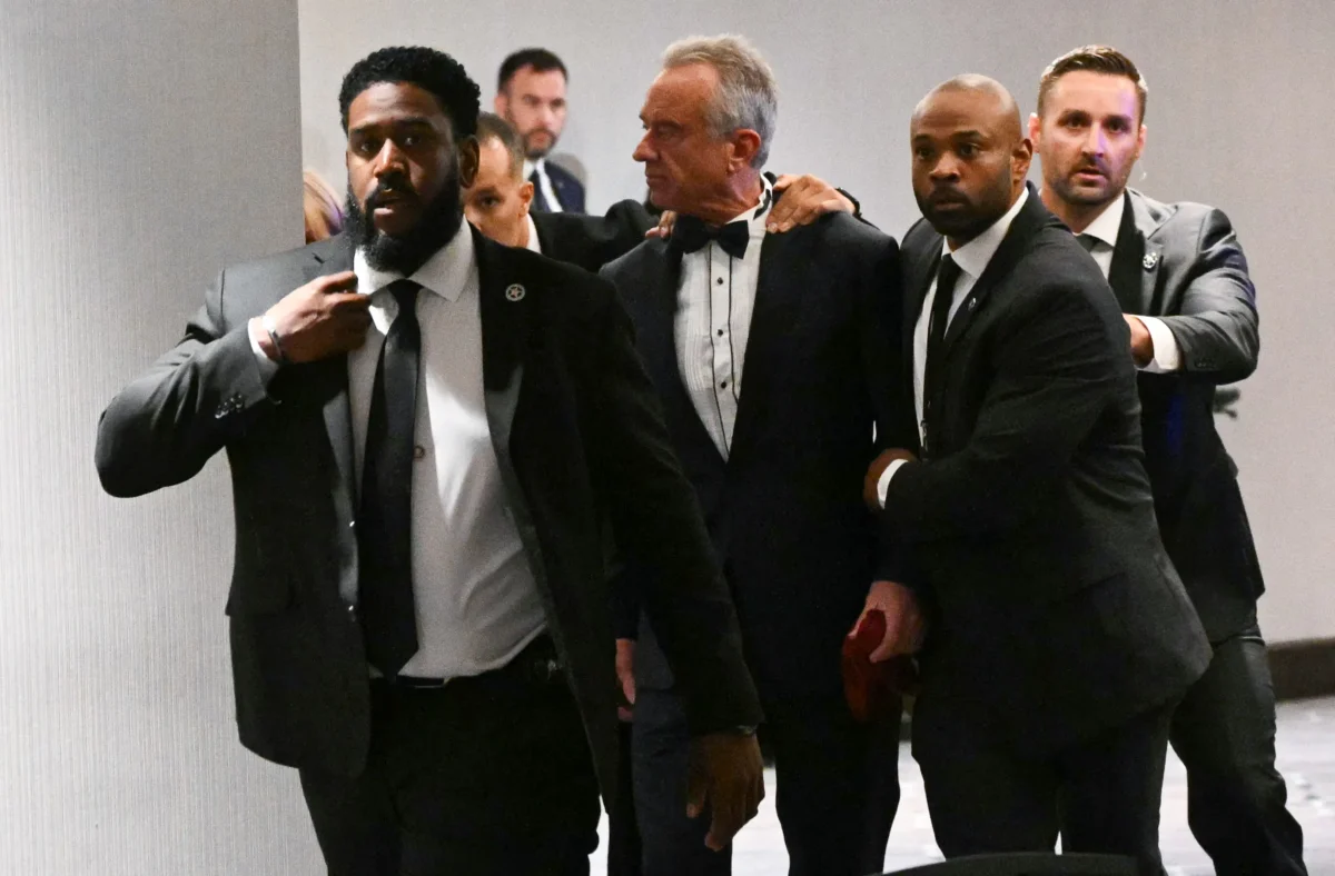 Health Secretary Robert F. Kennedy Jr. is rushed out by Secret Service agents after loud bangs were heard during the White House Correspondents' dinner at the Washington Hilton in Washington on April 25, 2026. (Mandel Ngan/AFP via Getty Images)