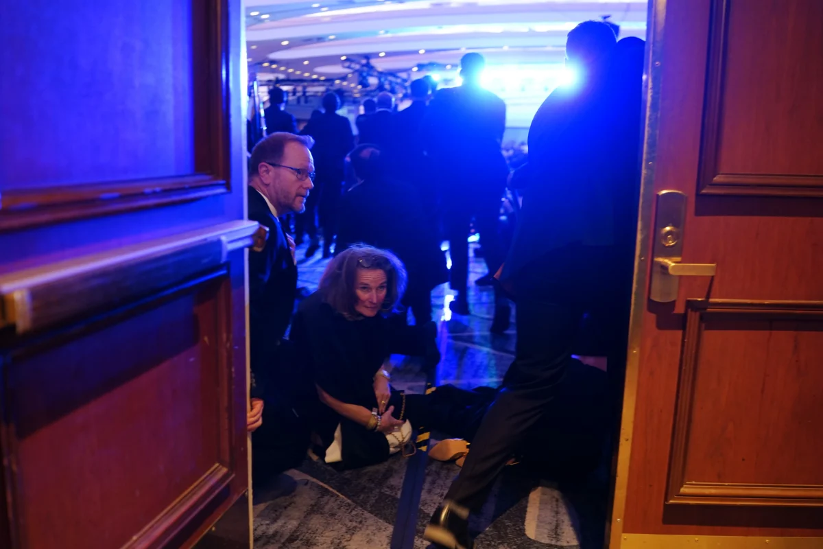 People take cover after an incident at the annual White House Correspondents Association Dinner in Washington on April 25, 2026. (Nathan Howard/Getty Images)