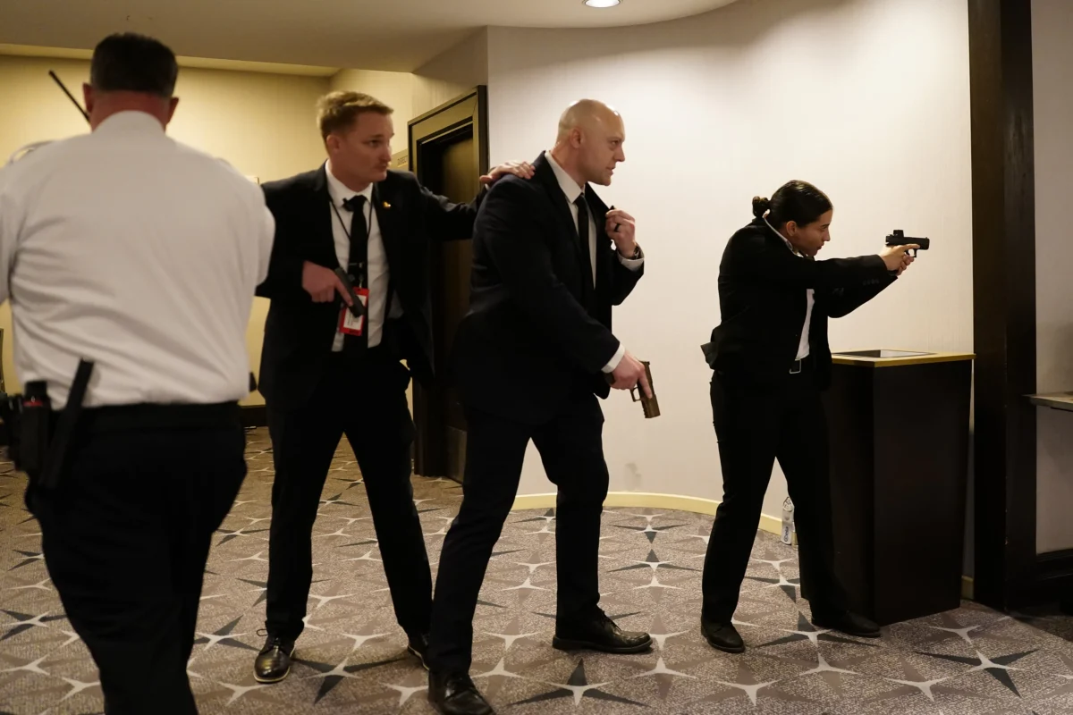 Federal agents draw their guns out after an incident at the annual White House Correspondents' Association Dinner in Washington on April 25, 2026. (Nathan Howard/Getty Images)